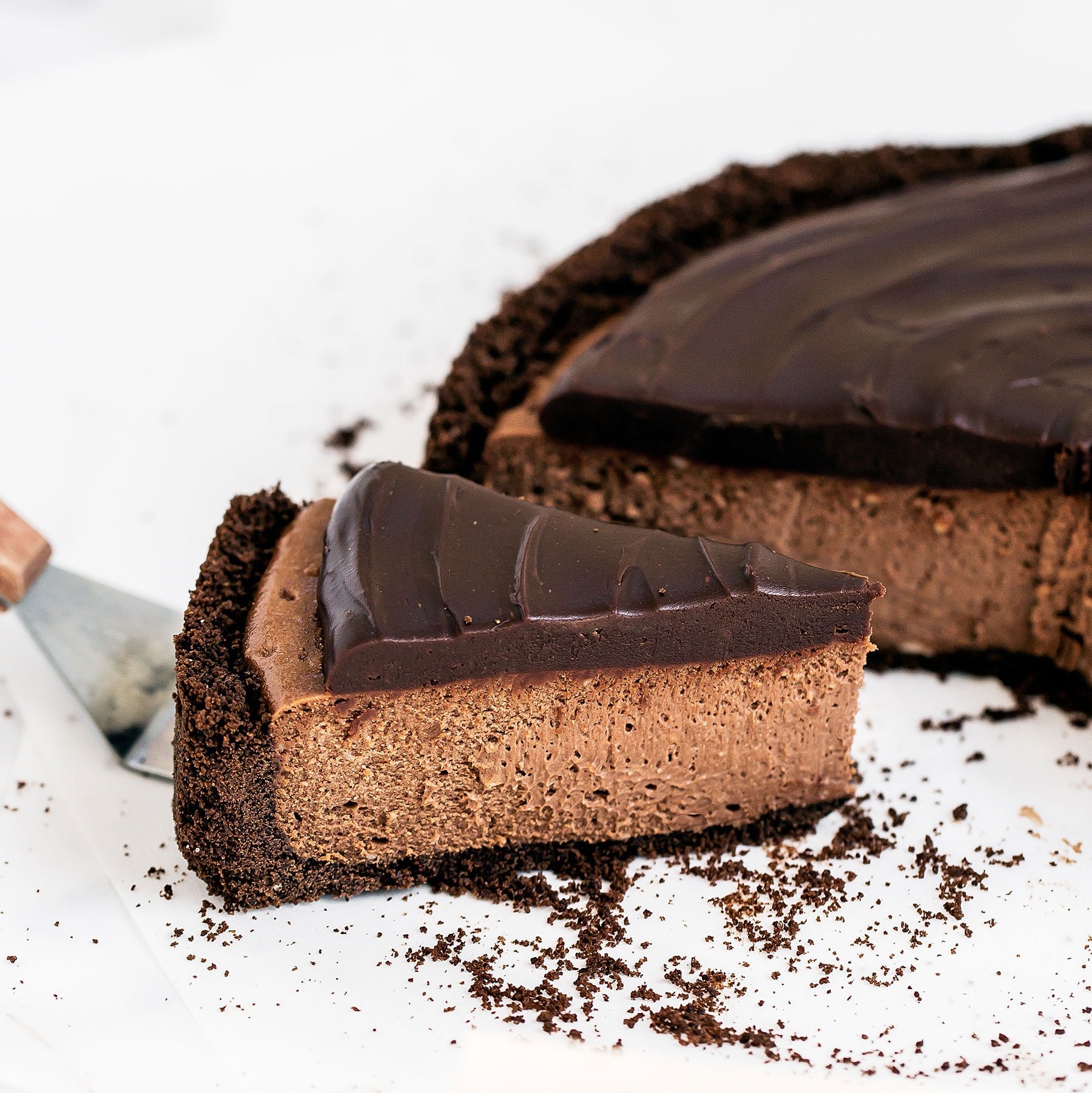 Insanely decadent Death by Chocolate Cheesecake features chocolate in FOUR forms: chocolate cookie crust, double chocolate cheesecake filling, with a chocolate ganache topping. It doesn't get better than this!